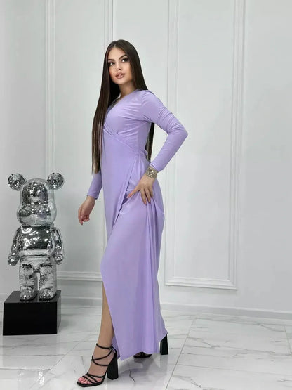 Lilac Mirage Maxi Dress showcasing elegant wrap design, long sleeves, with a high side slit and ankle-skimming length.