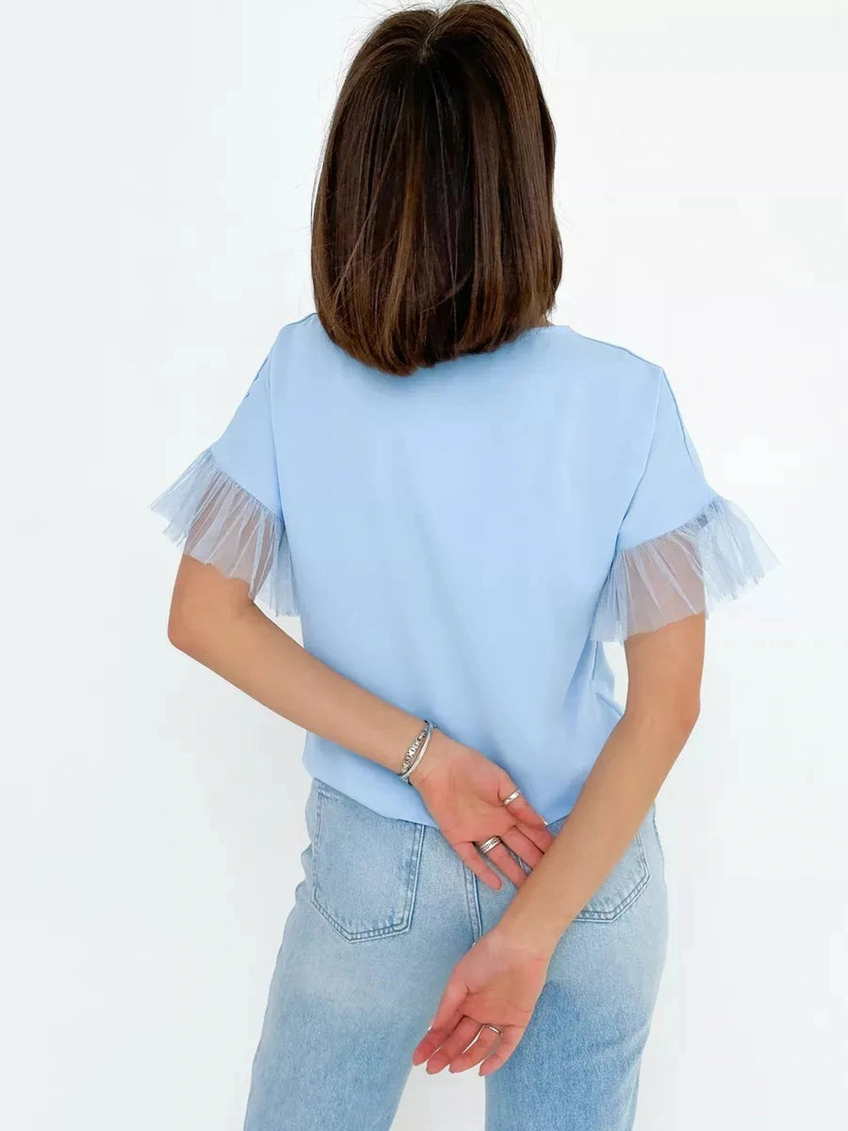 Celeste Blouse by Lauven showcasing a light blue silky top with tulle details, perfect for stylish occasions.