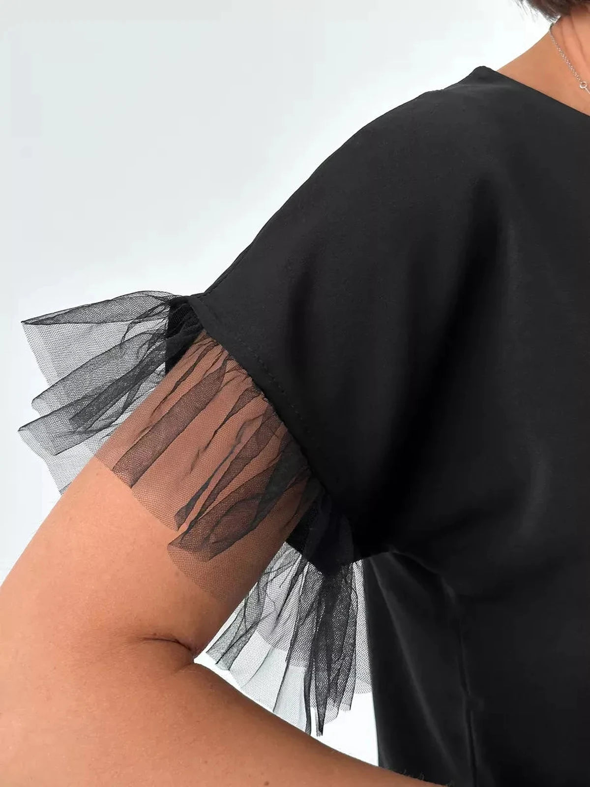 Noiré Blouse by Lauven featuring elegant black tulle ruffle detail on short sleeves.