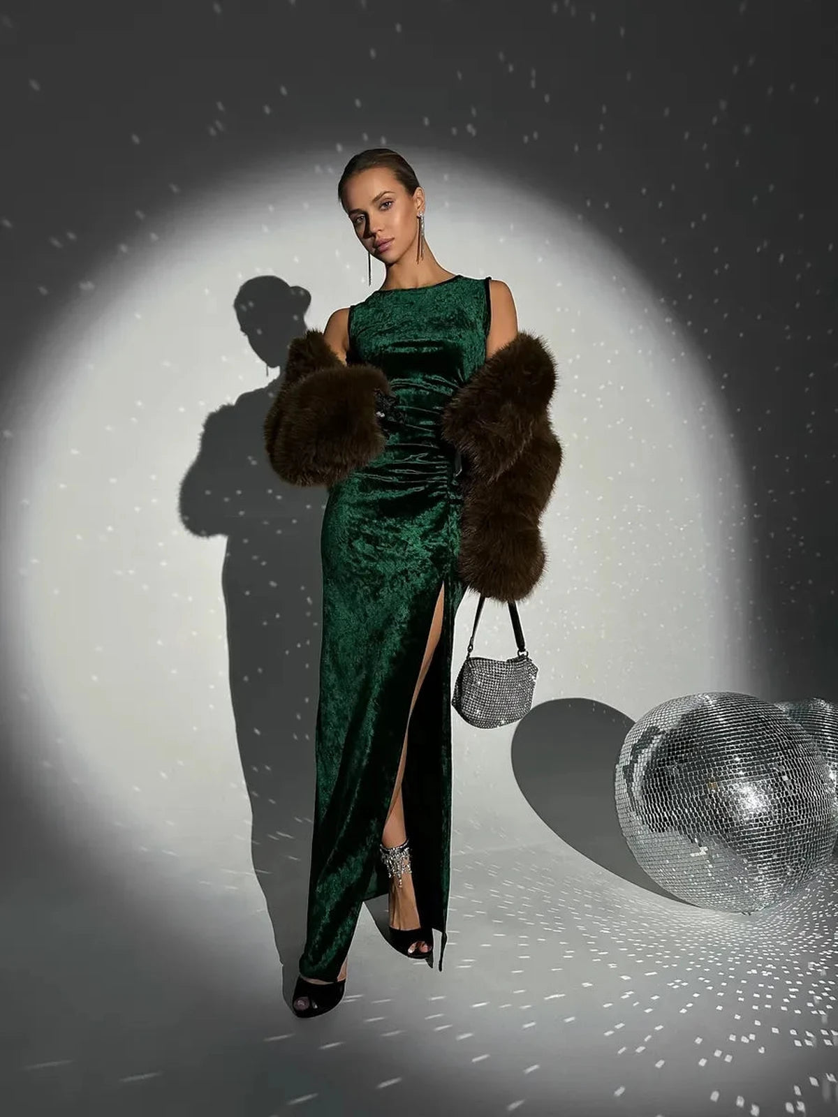 Emeralda Maxi Dress by Lauven featuring emerald green velvet, elegant draping, high slit, and chic accessories.