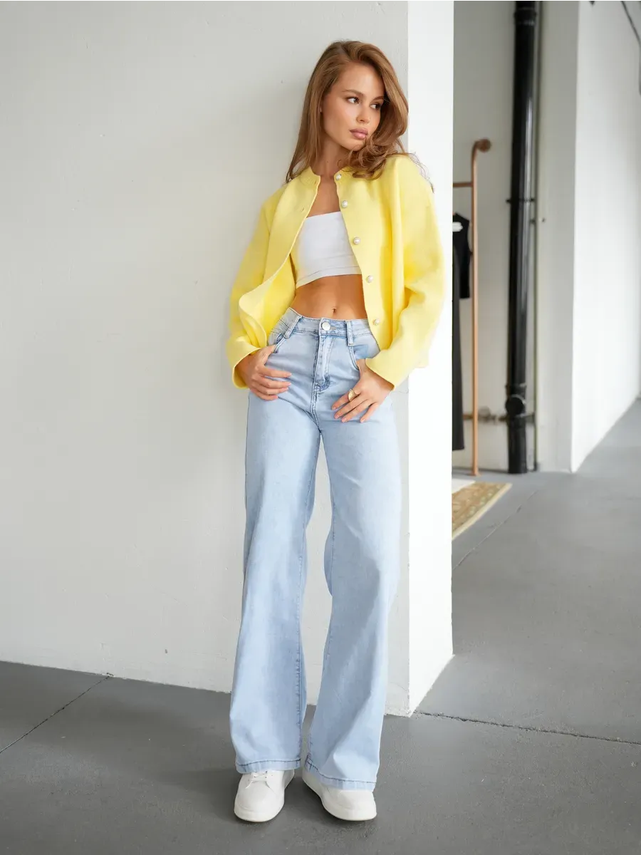 Model wearing Lemonade Cardigan by Lauven, styled with a cropped top and light jeans for a chic casual look.