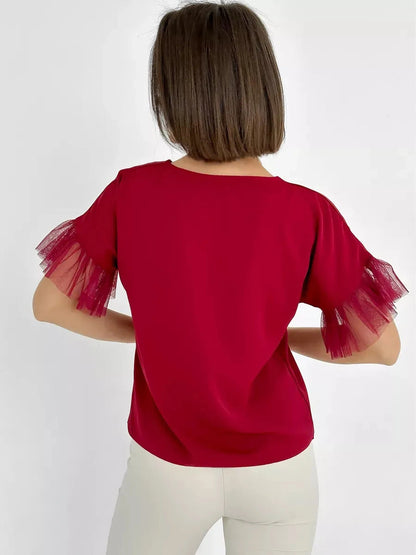 Back view of the Velora Blouse by Lauven, featuring burgundy fabric and sheer ruffle sleeves.