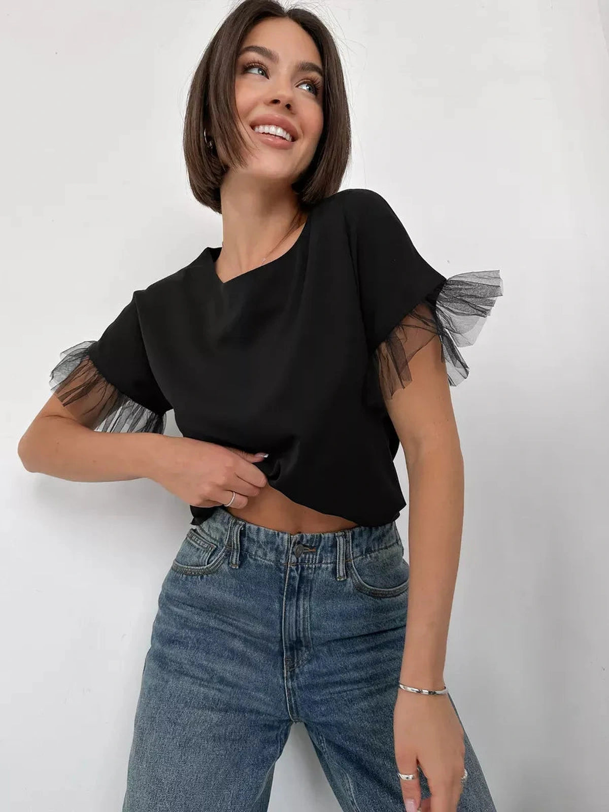 Noiré Blouse by Lauven, elegant black short sleeve blouse with tulle ruffle detail.