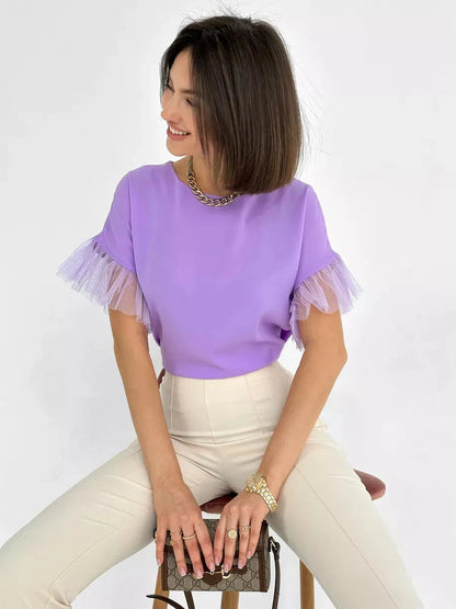 Lavande Blouse by Lauven featuring a lilac short sleeve design with sheer ruffle detail.