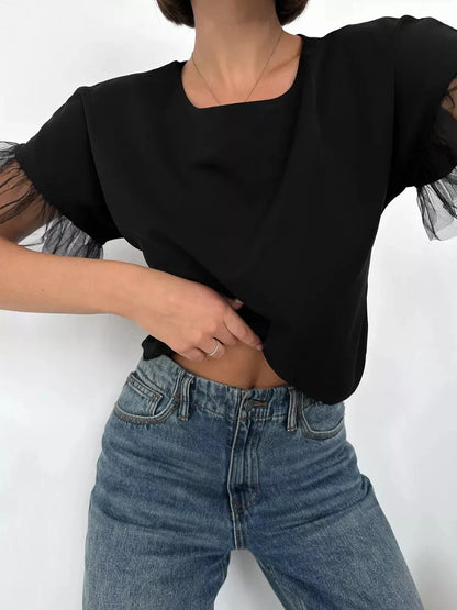 Noiré Blouse by Lauven, elegant short sleeve black blouse with tulle ruffle detail, perfect for warm seasons.