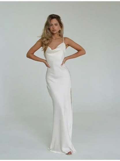 Model wearing an Ivory Luxe Maxi Dress featuring a cowl neckline and high side slit, showcasing elegant summer style.
