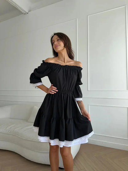 Model in a black off-shoulder mini dress featuring tiered ruffles and white lace trim, ideal for a romantic occasion.