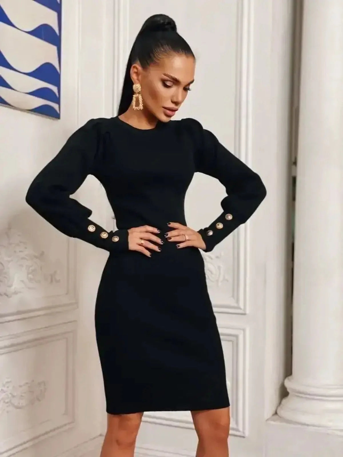 Elegant black mini dress with gathered shoulders and gold-tone buttons, showcasing refined style and sophistication.