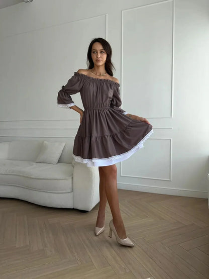 Model in an off-shoulder mocha dress with white ruffle trim, showcasing a graceful A-line silhouette.