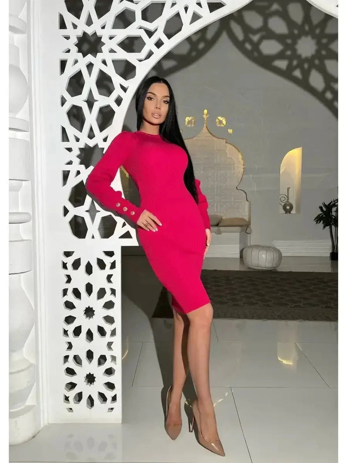 Fuchsia ribbed knit mini dress with puffed sleeves and button details, worn by model in elegant interior.