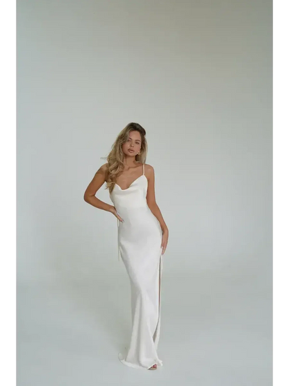 Model wearing the Ivory Luxe Maxi Dress, showcasing its silky drape and high side slit against a neutral background.