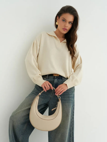 Model wearing a Linen Sweater by Lauven, showcasing a light beige oversized knit with subtle prints.