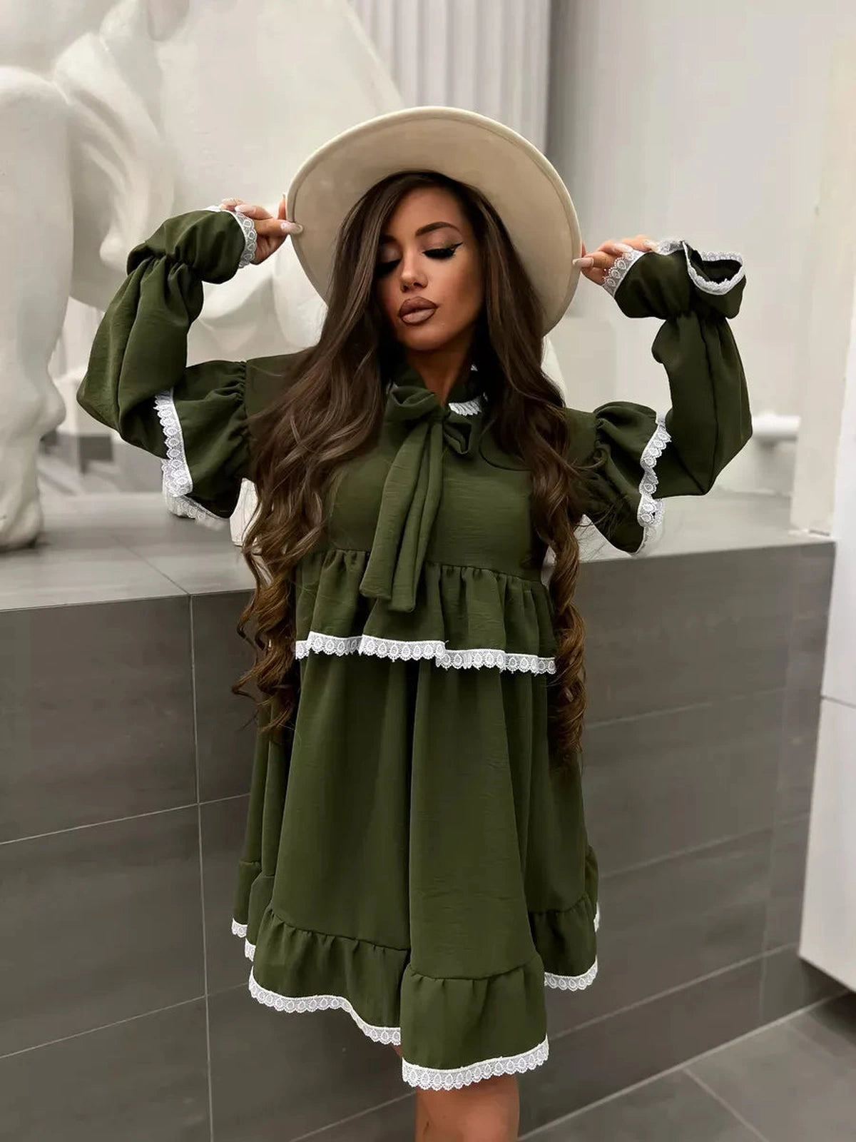 Olivea Mini Dress by Lauven in khaki with ruffles and lace trim, featuring an oversized fit and stylish hat.