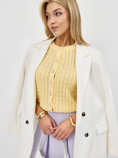 Model wearing Solara Cardigan in soft yellow, showcasing breathable cotton-acrylic knitwear by Lauven.