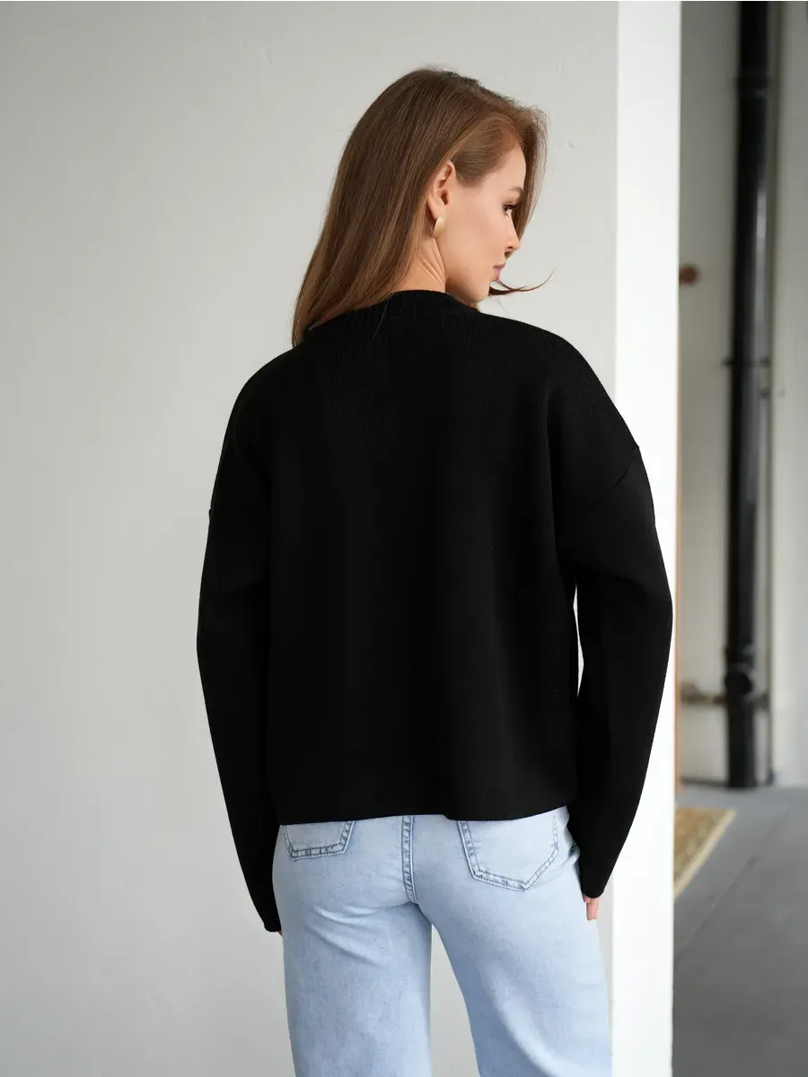 Noir Cardigan by Lauven - Stylish black knit cardigan viewed from the back, paired with light jeans