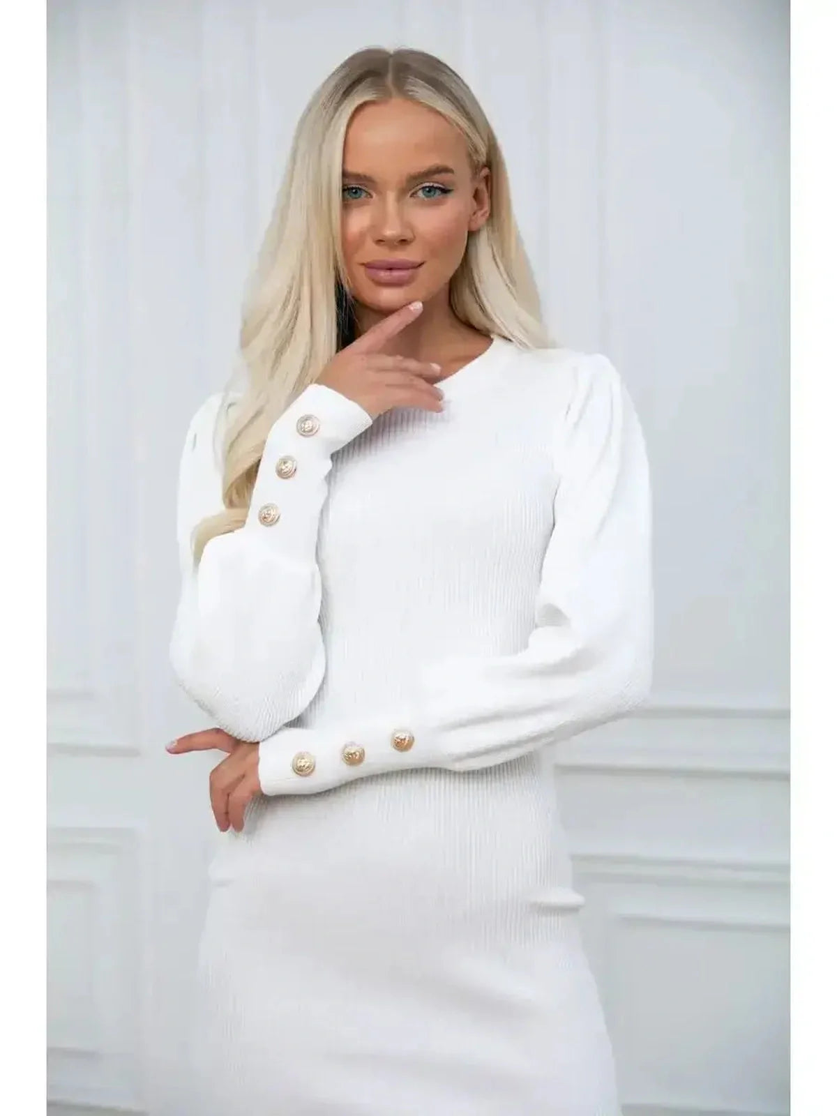 Model wearing the Ivory Curve white dress featuring voluminous sleeves and buttoned cuffs for a sophisticated look.