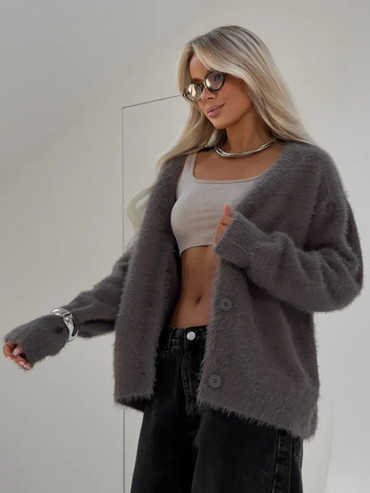Model wearing Vega Cardigan by Lauven, an oversized gray fluffy knit cardigan with button closure.