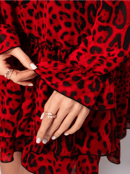 Savanna Mini Dress by Lauven featuring red leopard chiffon fabric and elegant bell sleeves.