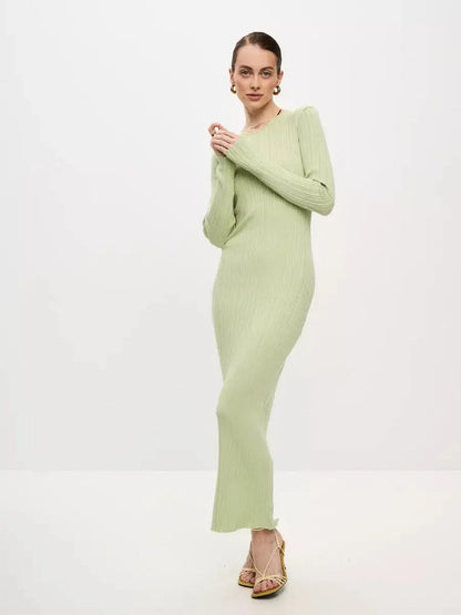 Model wearing the Celery Luxe Maxi Dress, a light green ribbed knit dress showcasing seamless elegance and sculpted fit.