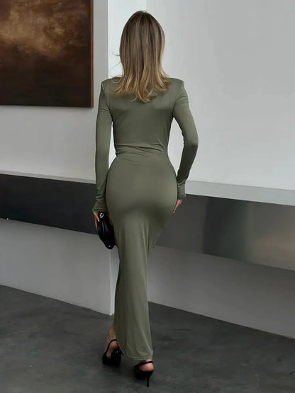 Back view of a woman in a light sage Sculpted Drape Maxi Dress, showcasing a sleek silhouette and elegant design.