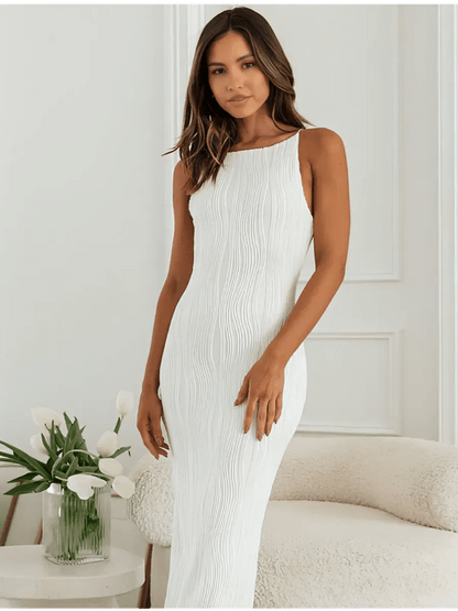Ivory Wave Maxi Dress featuring sculpted texture and minimalist elegance on a model against a light backdrop.