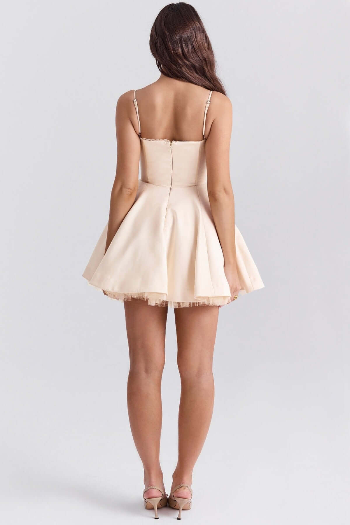 Back view of a Inez Mini Dress in soft beige, featuring a fluffy skirt ideal for summer weddings and special occasions.