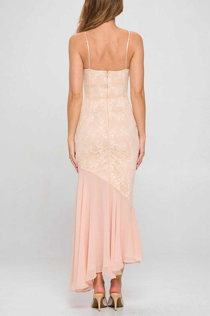 Back view of the Iris Women’s dress, an elegant asymmetrical gown in soft peach lace with a flowing chiffon skirt.