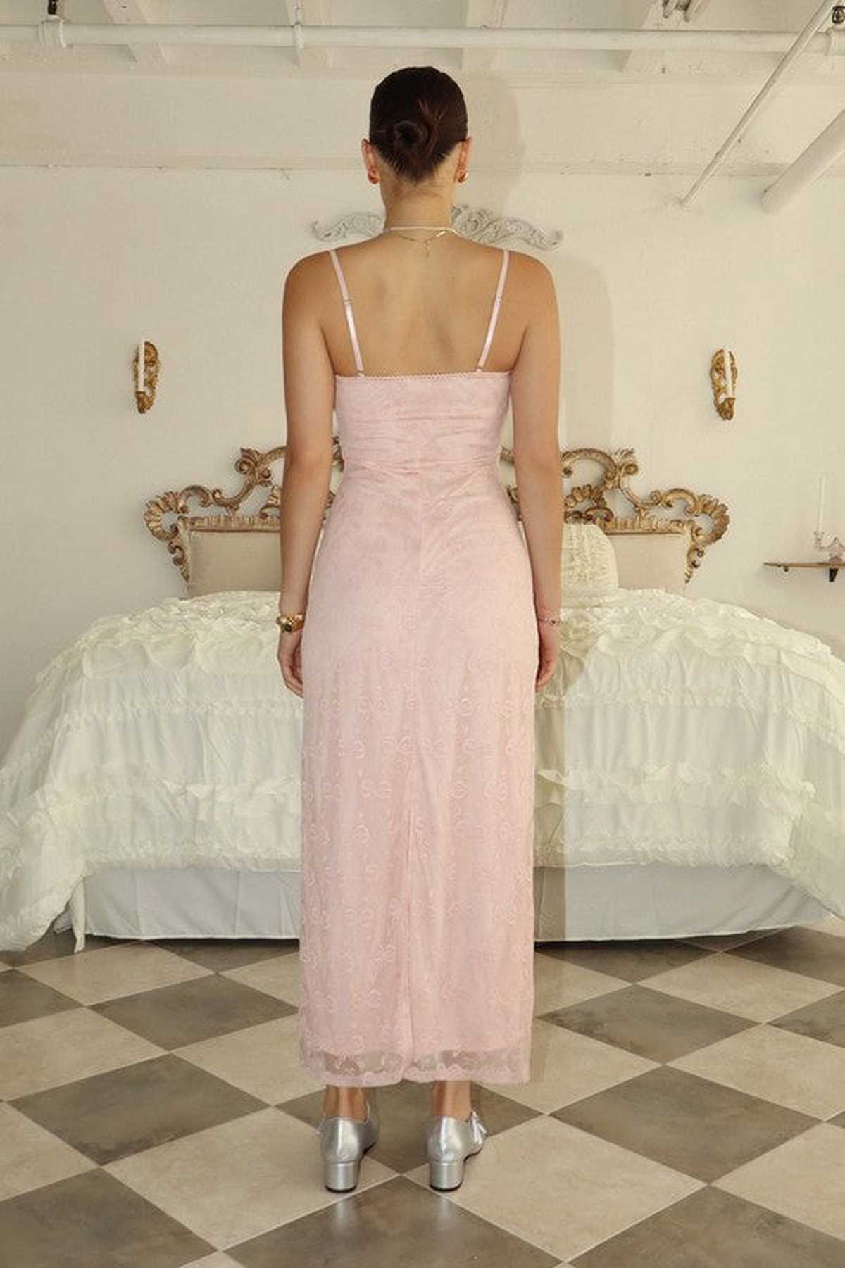 Back view of a woman in a blush pink maxi dress, perfect for weddings, proms, and formal occasions.