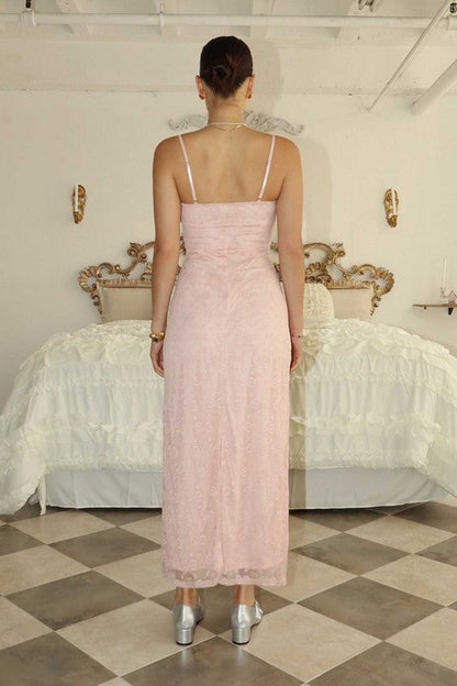 Back view of a woman in a blush pink maxi dress, perfect for weddings, proms, and formal occasions.