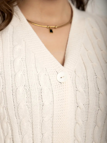 Close-up of the Isola Cardigan by Lauven, featuring a cream knit texture and button closure, perfect for stylish layering.