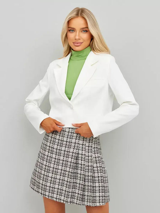 Ivory Blazer by Lauven styled with a green turtleneck and plaid skirt for a chic look.