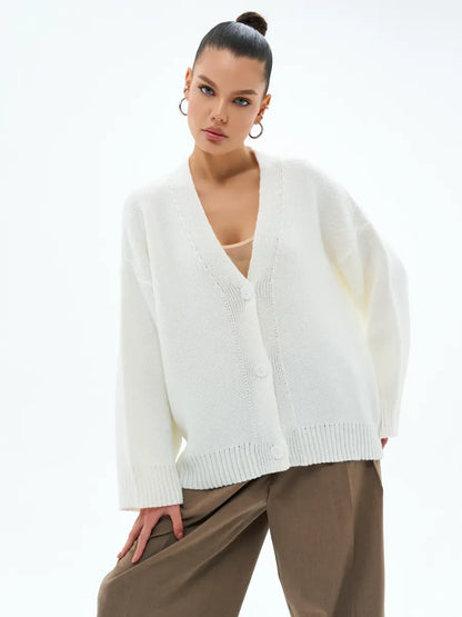 Model showcasing Ivory Cardigan by Lauven, a cozy oversized knitwear piece with button closure.