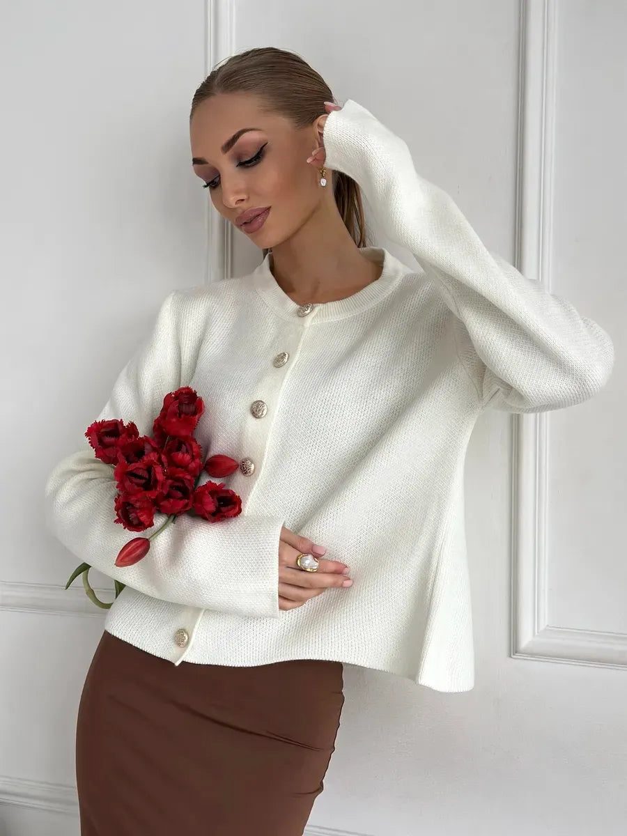 Ivory Cardigan by Lauven, elegant cropped knitwear with button closure, styled with vibrant flowers.