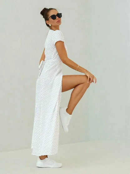 Ivory Dots Maxi Dress featuring a wrap silhouette, short sleeves, and chic black polka dots for summer elegance.