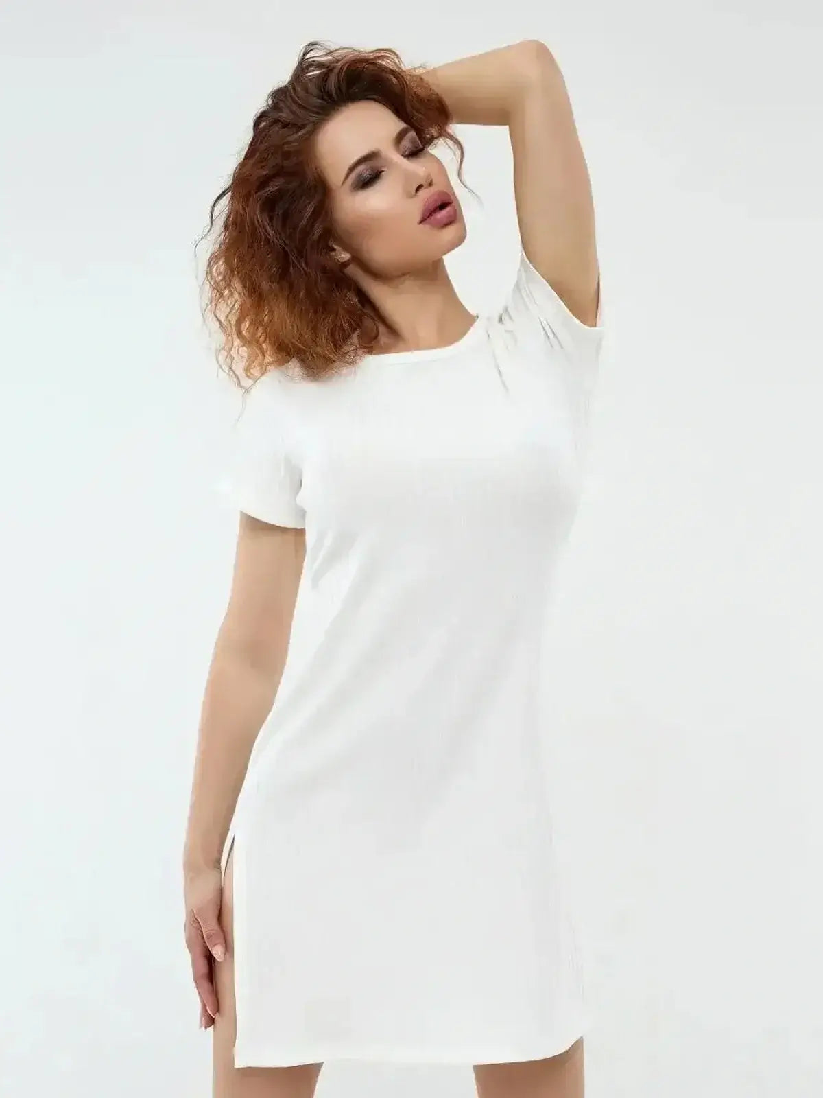 Ivory Glow mini dress by Lauven in white, showcasing a sleek silhouette and modern side slits, perfect for warm weather.