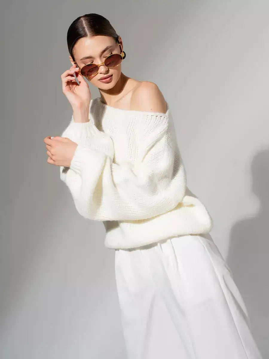 Model wearing Lauven Ivory Sweater oversized off-shoulder knit in white, showcasing a chic and elegant look.