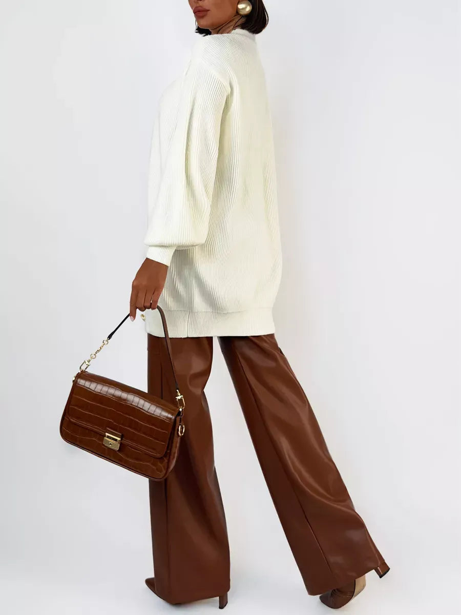 Ivorya Cardigan by Lauven, longline oversized knit in elegant cream, styled with brown wide-leg pants and handbag.