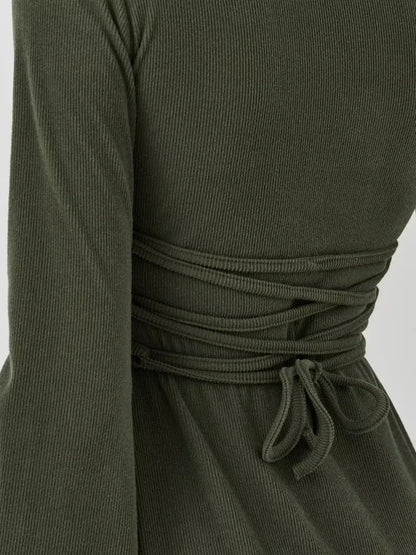 Back detail of the Ivy Bell mini dress by Lauven, featuring elegant waist cinching and stylish flared bell sleeves.