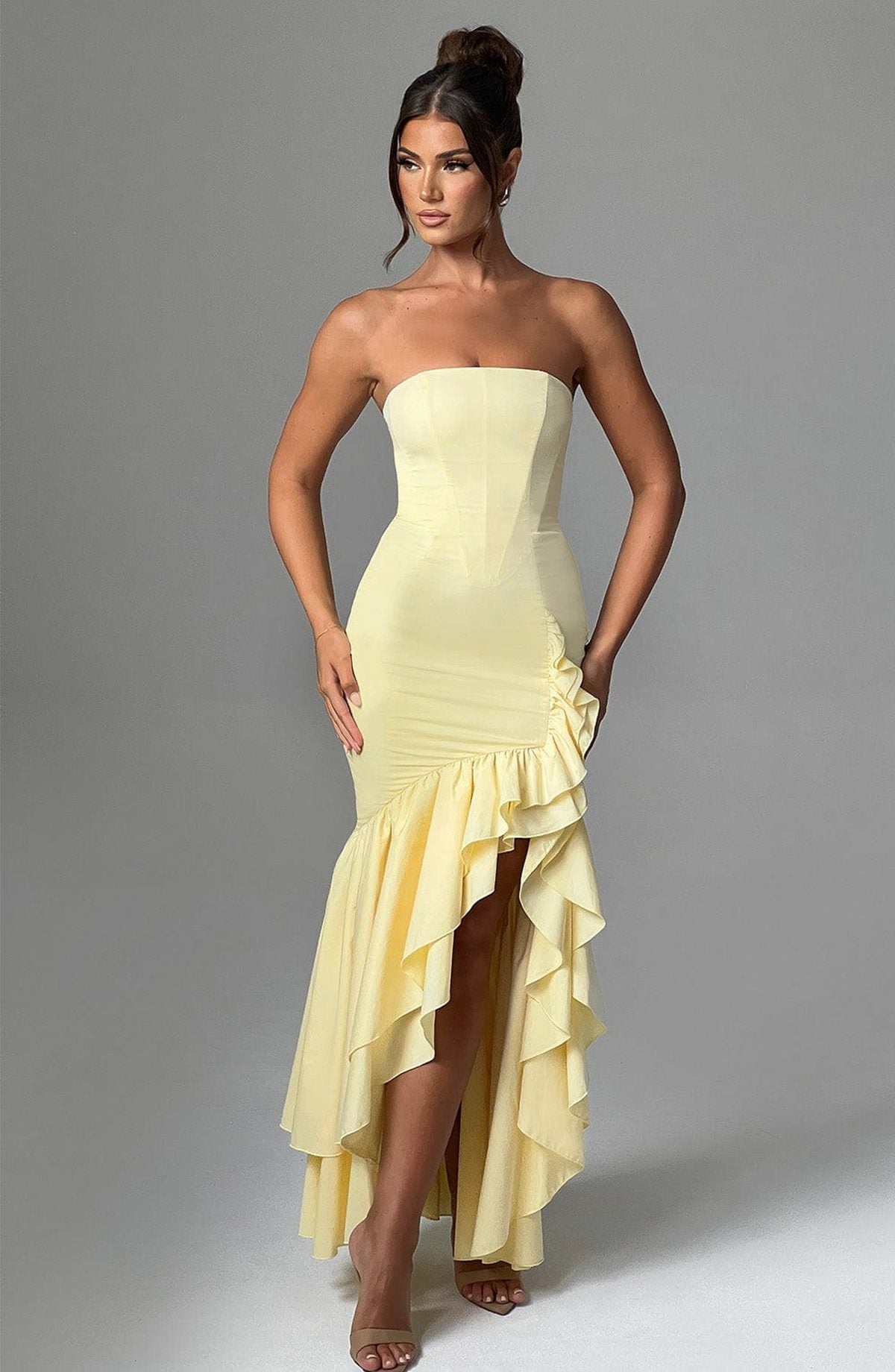 Jasmine Women’s Dress in yellow, featuring a strapless design, dramatic ruffles, and high leg slit, ideal for summer events.
