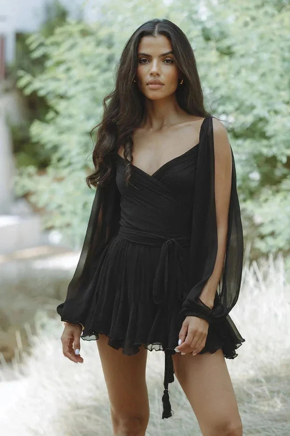Elegant black mini dress with balloon sleeves, perfect for summer parties and stylish events.