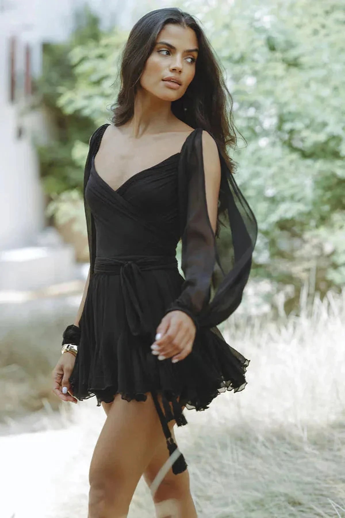 Elegant black mini dress with balloon sleeves, perfect for cocktail parties and special events.