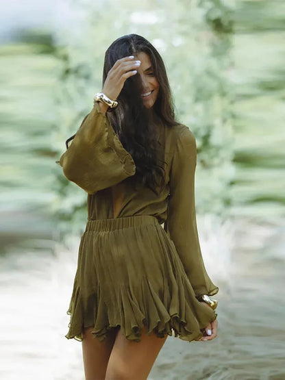 Chic woman wearing an olive green mini dress with balloon sleeves, perfect for summer or casual occasions.