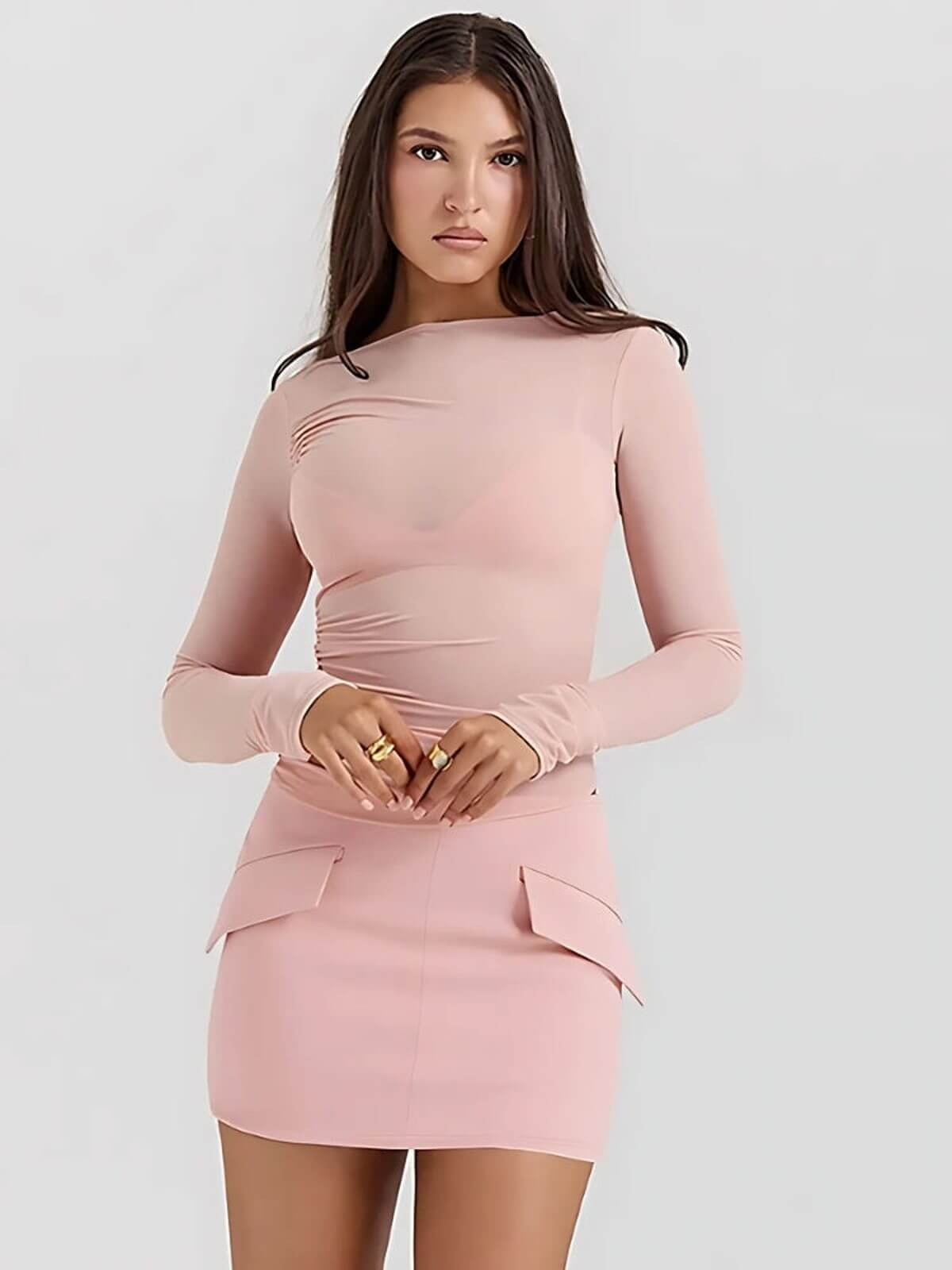Elegantly styled pink Juno Mini Dress featuring long sleeves and ruched detailing, perfect for summer or cocktail occasions.