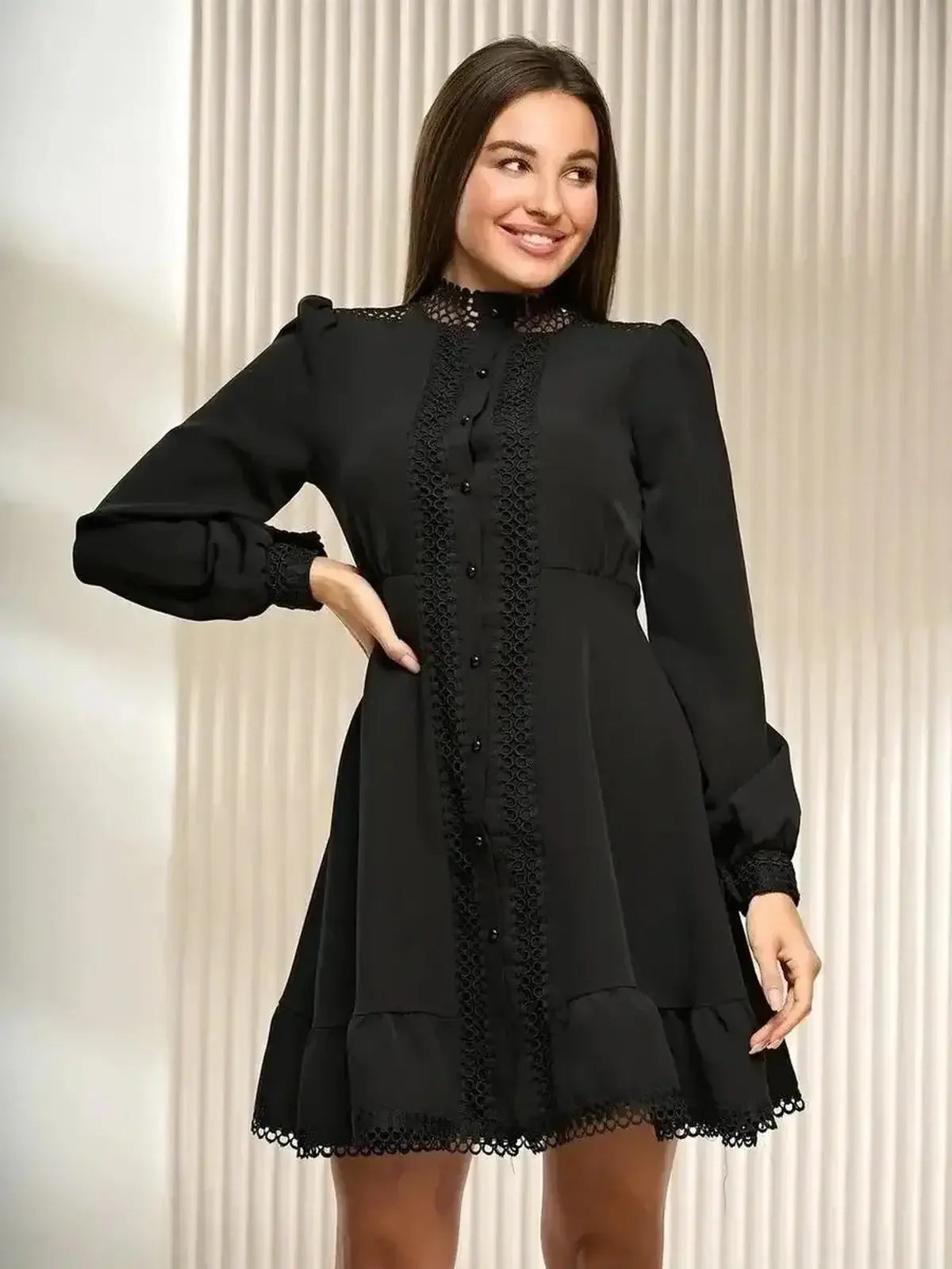 Black mini dress with lace trim and long sleeves, perfect for formal events and special occasions.