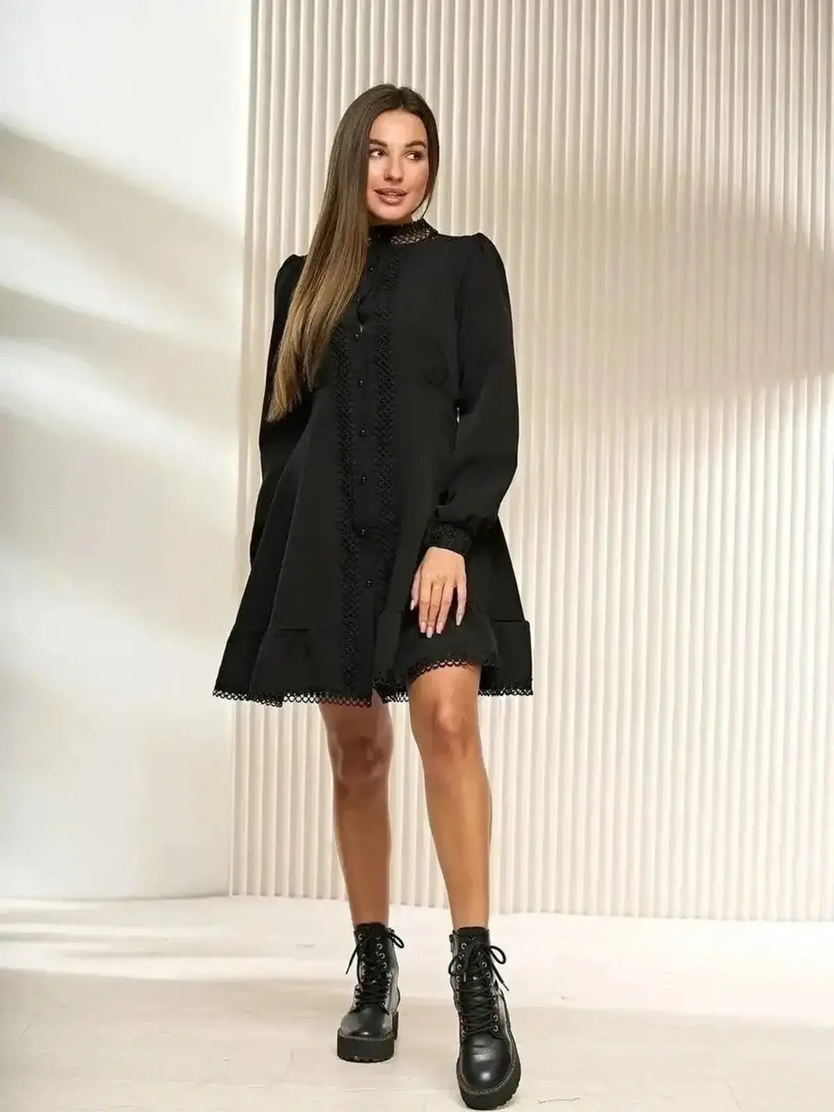 Black mini dress with lace trim, long sleeves, and a flared hem, perfect for weddings and formal events.