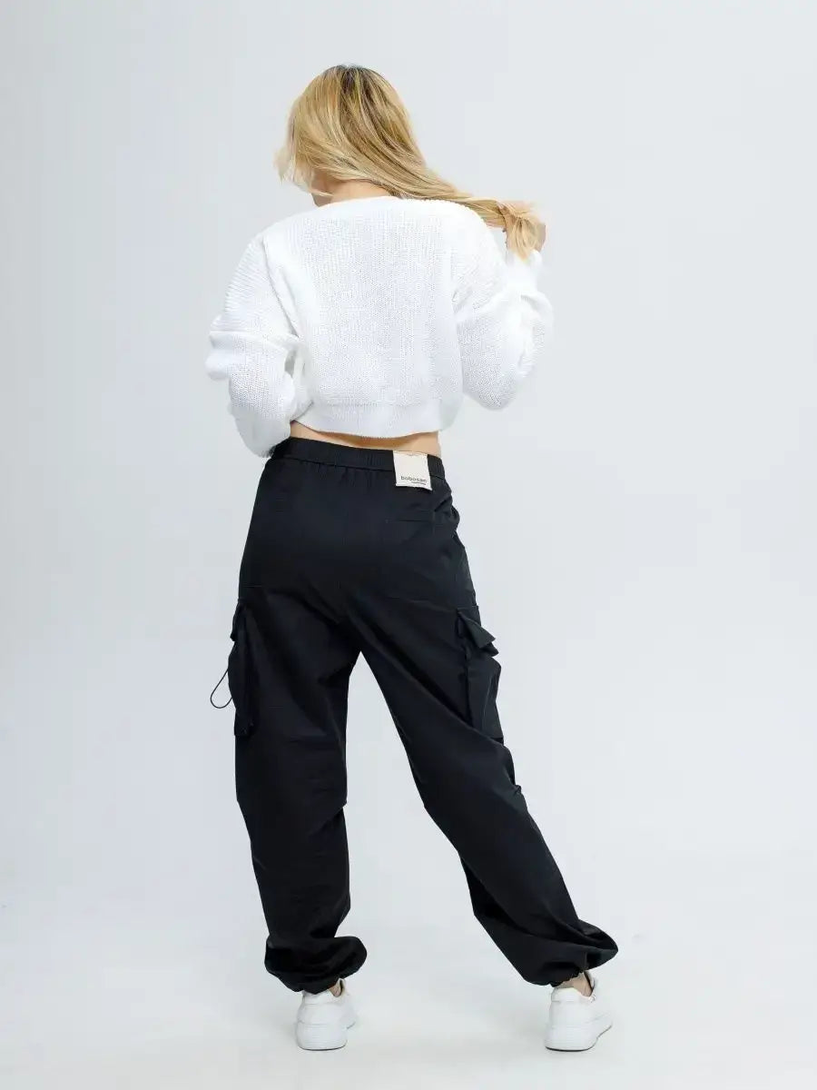 Alba Pullover by Lauven, a lightweight knit in soft white styled with black cargo pants.