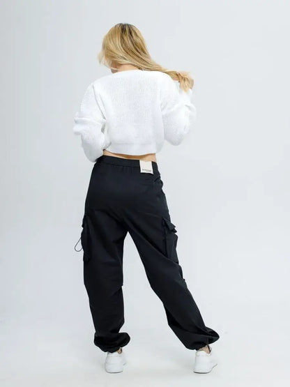Alba Pullover by Lauven, a lightweight knit in soft white styled with black cargo pants.