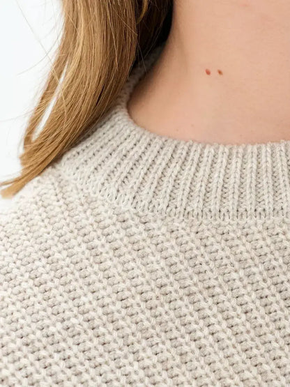 Close-up of the collar detail of the Astra Sweater by Lauven in light beige knit fabric.