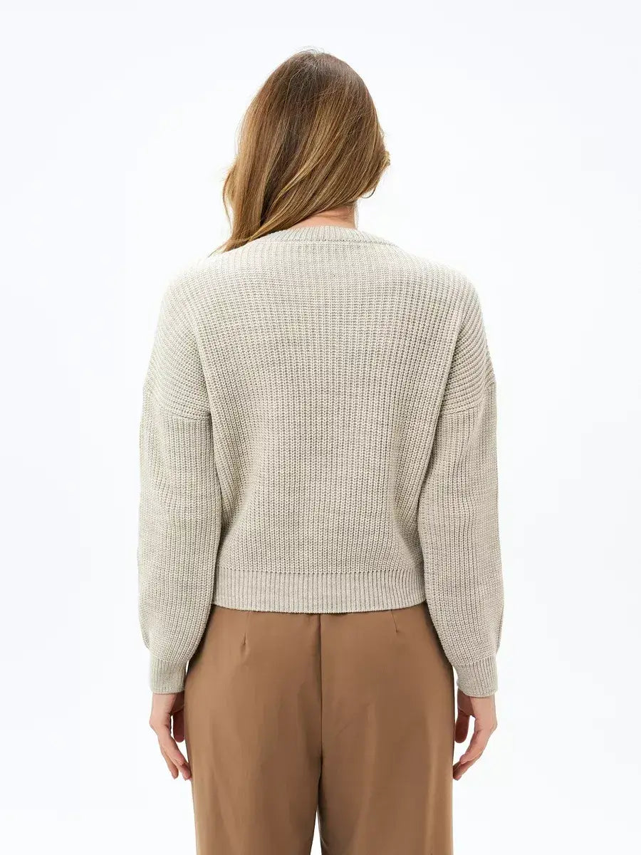 Back view of women’s Lauven Astra Sweater in light beige oversized knit, showcasing a relaxed fit and ribbed texture.