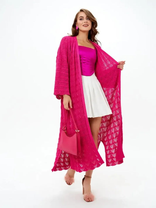 Model wearing a vibrant raspberry Berry Cardigan over a summer outfit by Lauven, showcasing its lightweight openwork knit design.